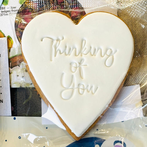 Heart-shaped cookie with 'Thinking of You' text 