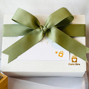White box with a green ribbon and 'Care Box' logo on a light background