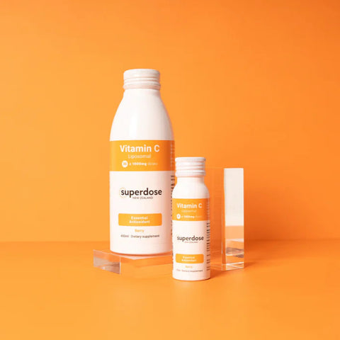 Supplement bottles with orange labels on an orange background