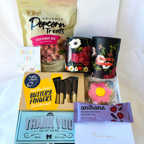Assorted snacks and treats including popcorn, candies, and chocolate bars on a white background
