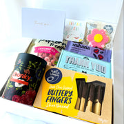 Assorted food items and cards in a box on a white background