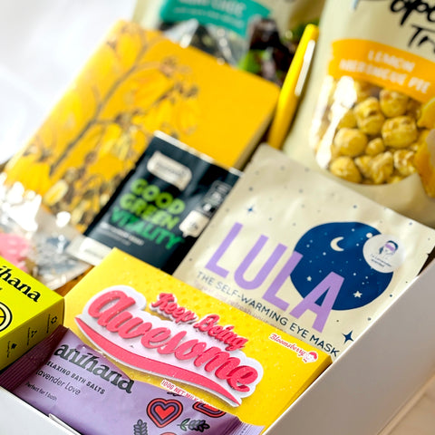 Assorted skincare and snack products including Lula eye masks and popcorn.