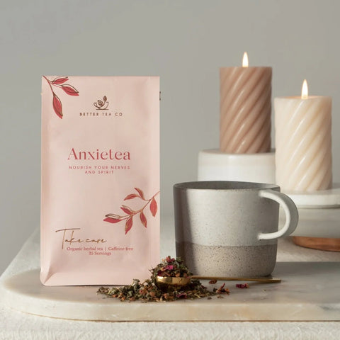 Anxietea tea packaging with a mug and candles on a neutral background