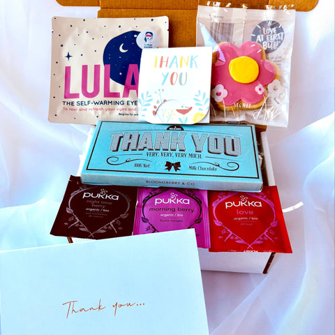 Collection of Pukka and Lula products on a white fabric background